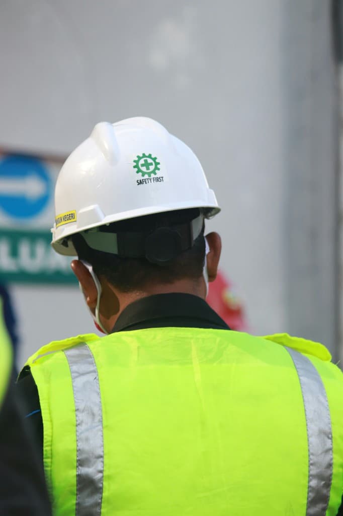 A person in a hard hat and high-visibility vest.
