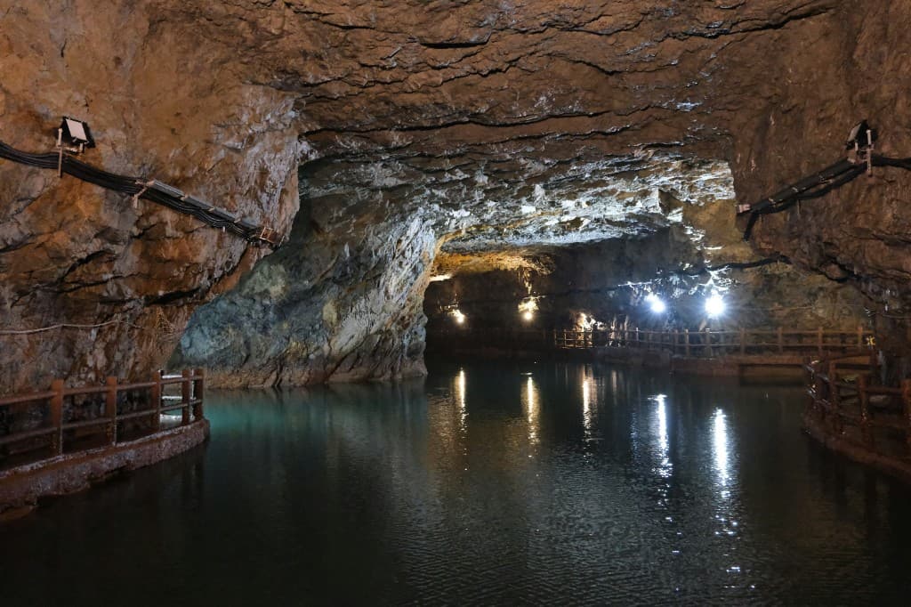An underground excavation with water on the floor.