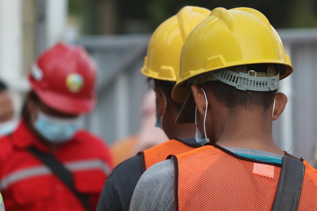 A shift crew in hard hats and high-visibility clothing.